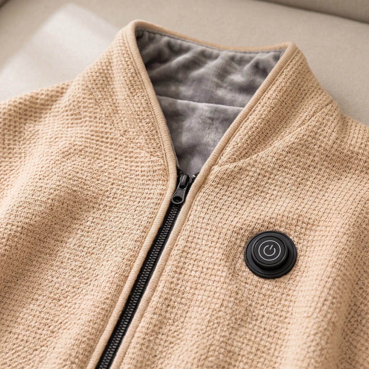 Close-up of the AerPack WarmWrap heat button and front zipper