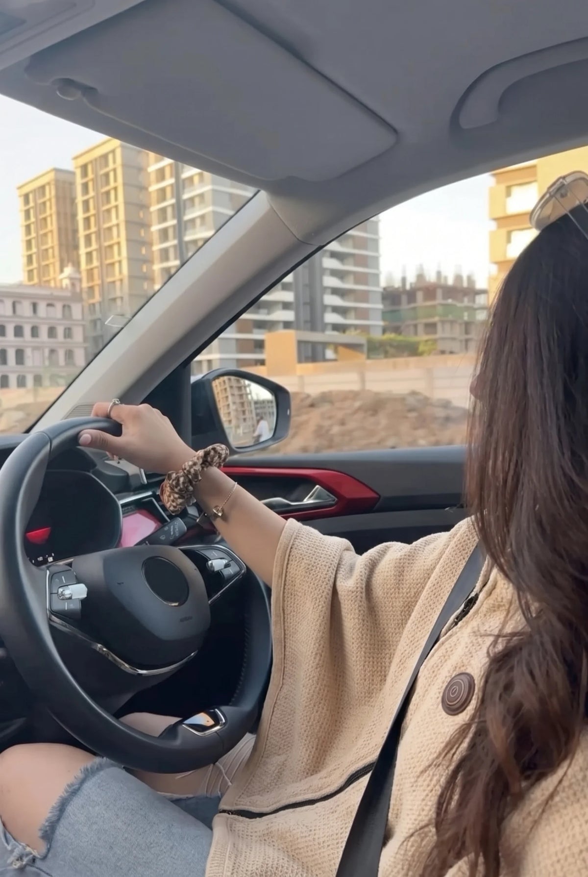 Woman in her car wearing the beige AerPack WarmWrap